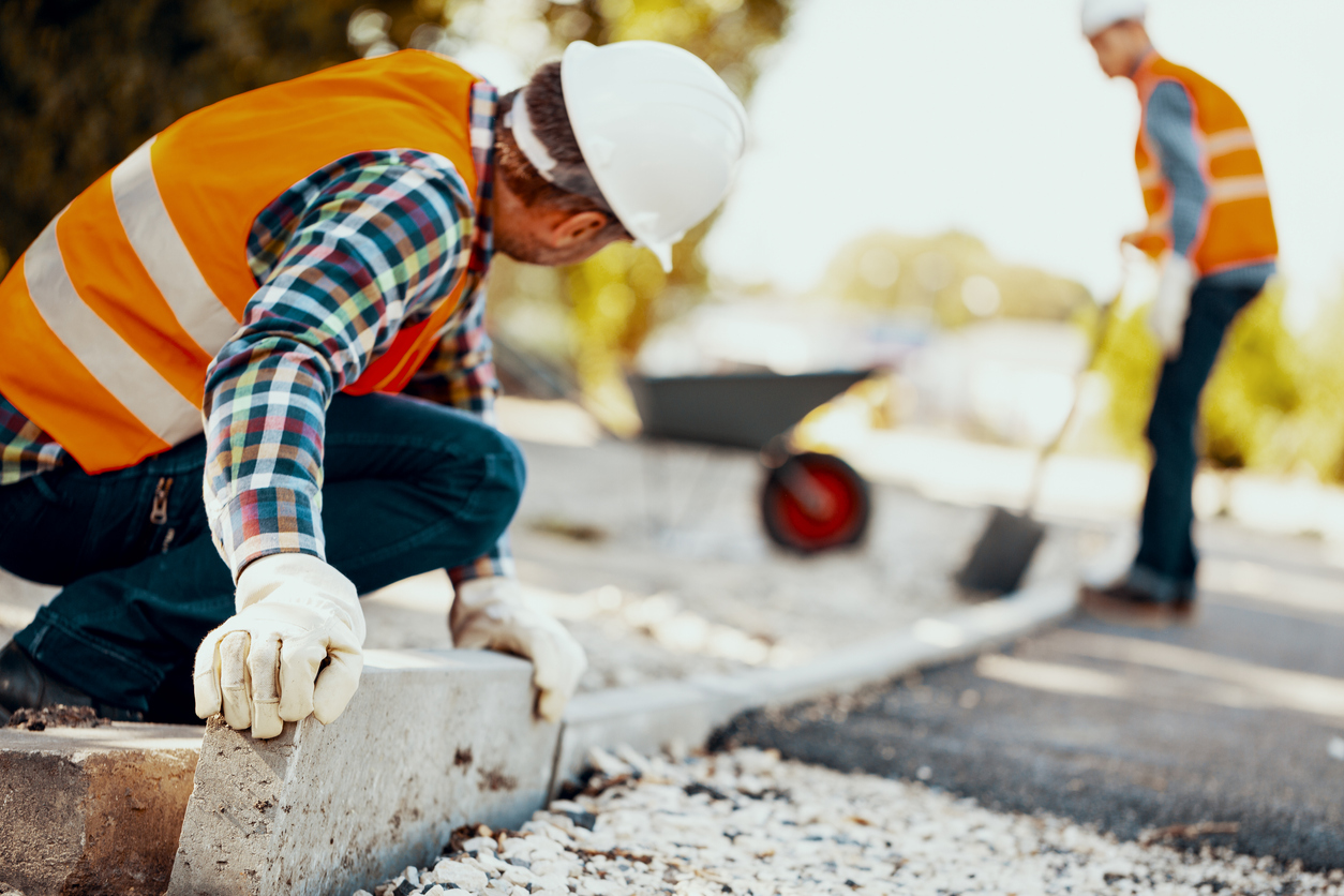 Construction workers wearing reflective tape.